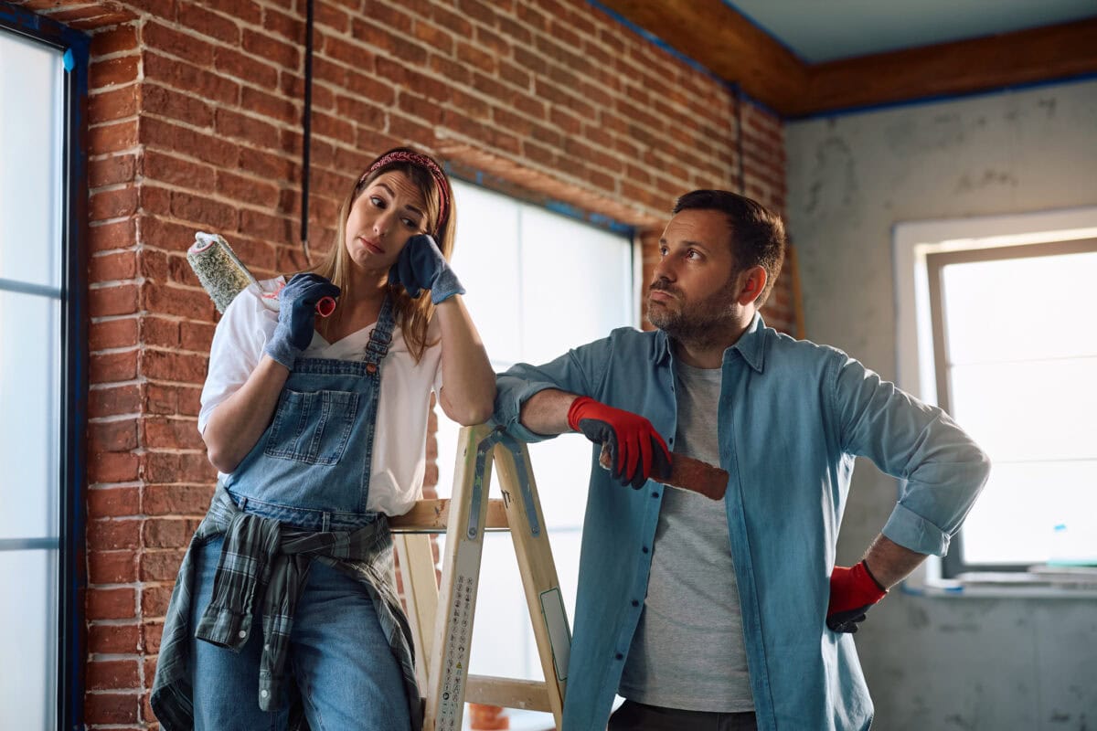 Displeased couple having problems during home renovation project.