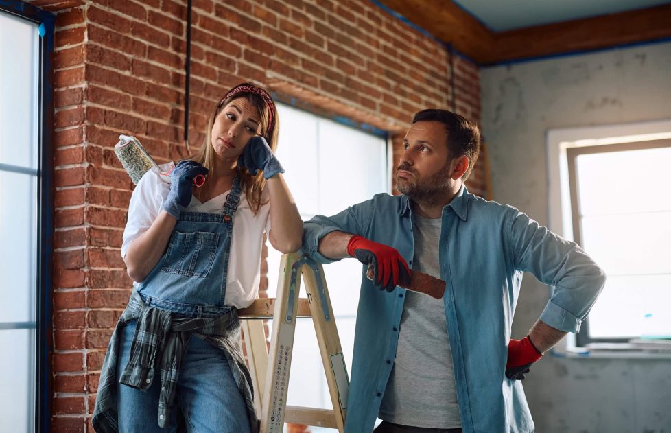 Displeased couple having problems during home renovation project.
