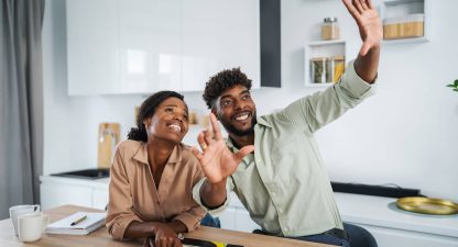 Young couple planning kitchen renovation selecting colors